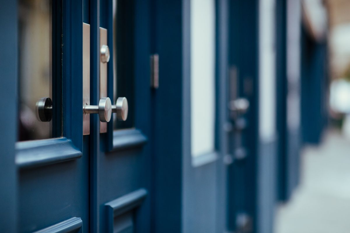 A set of painted doors with brass handles