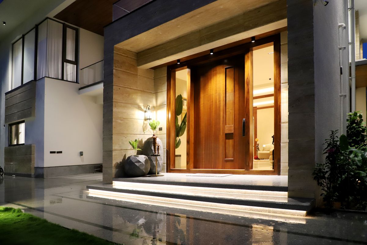 A modern home entrance lit up at night