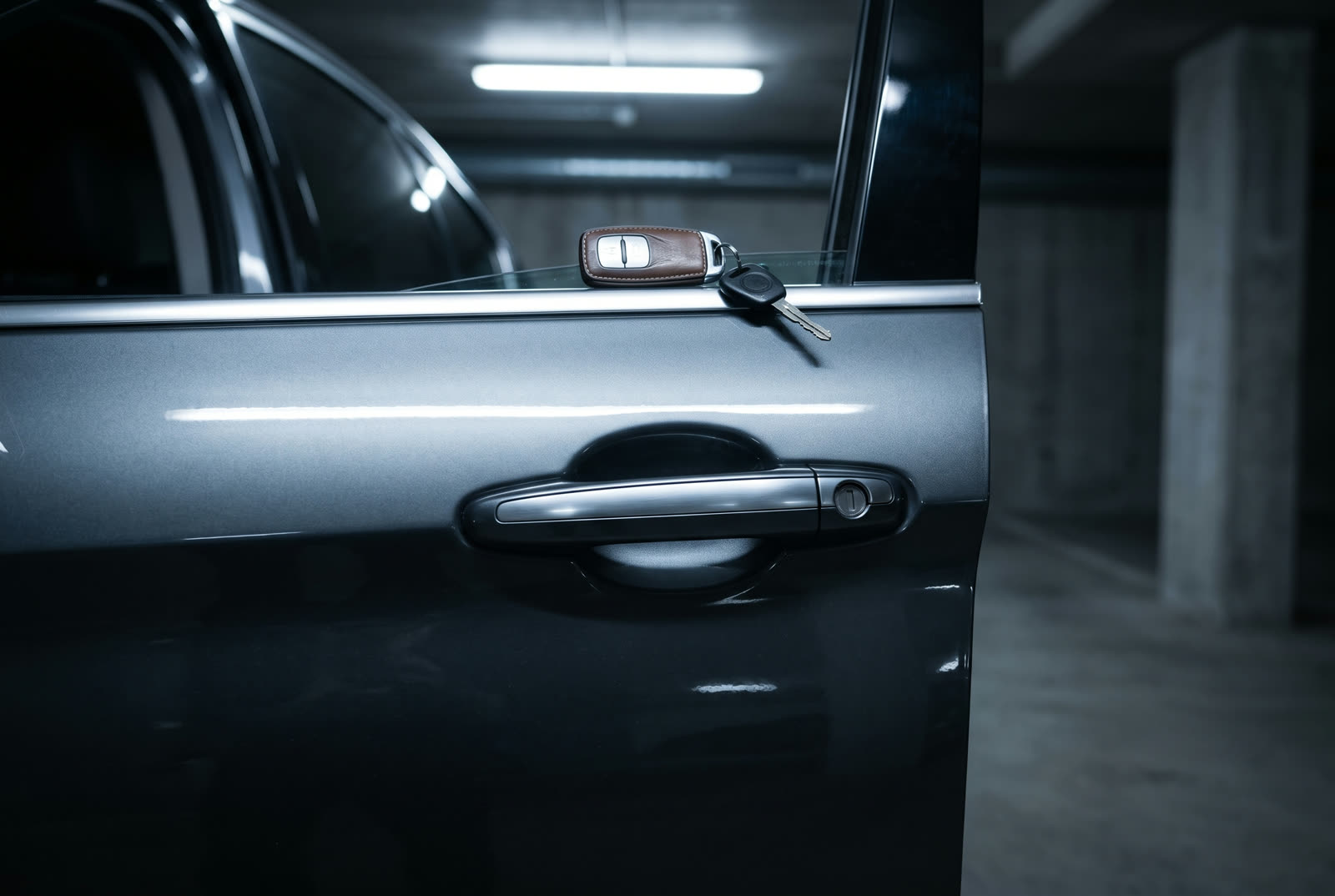 A mobile auto locksmith working at a vehicle in a Cape Town car park